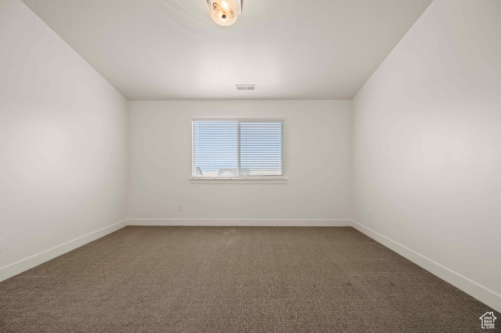 Spare room featuring carpet flooring