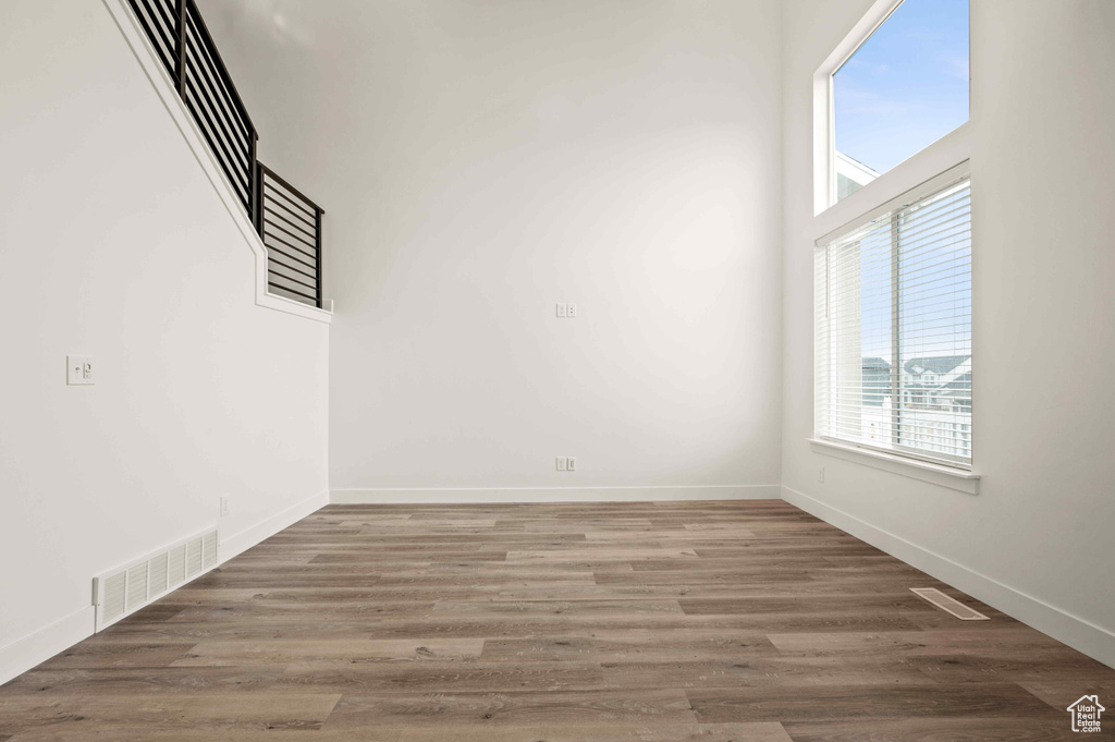 Spare room with baseboards and wood finished floors