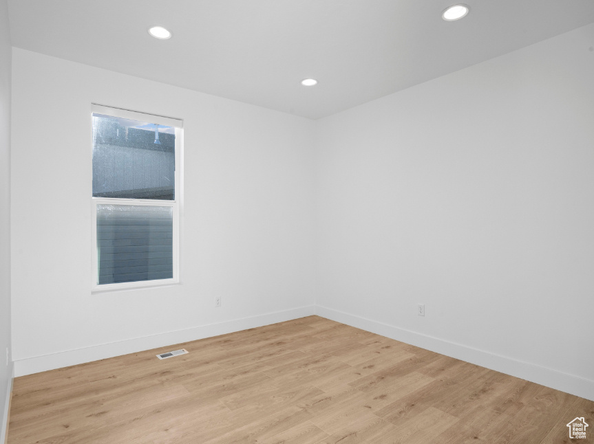Unfurnished room with light wood-type flooring and recessed lighting