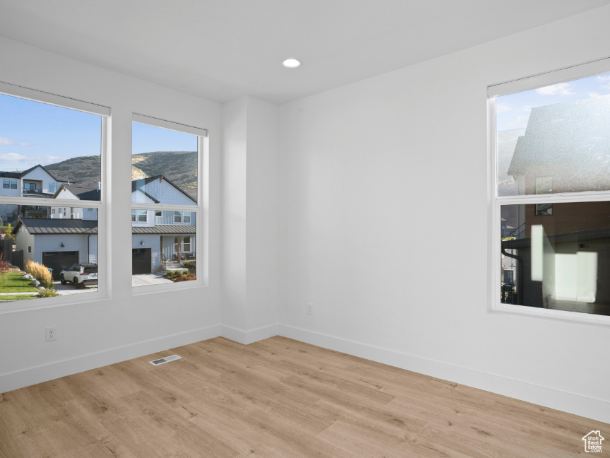 Unfurnished room featuring wood finished floors and recessed lighting