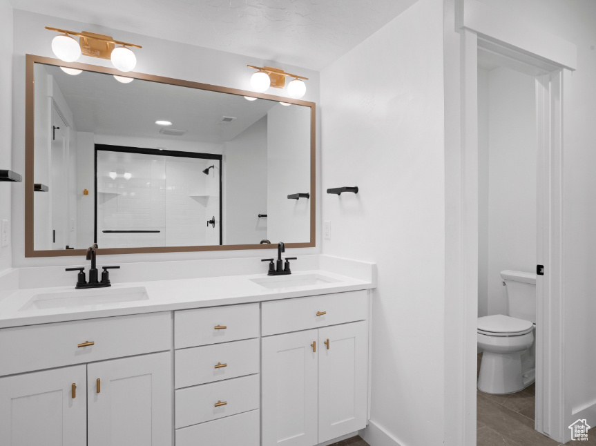 Full bathroom with double vanity and a walk in shower