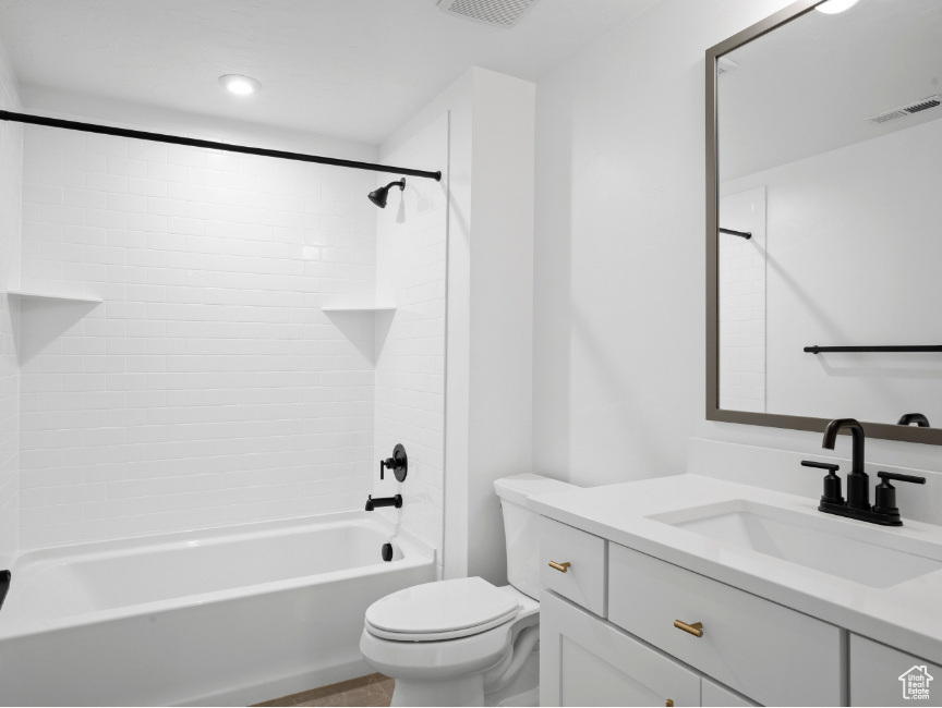 Bathroom featuring vanity and  shower combination