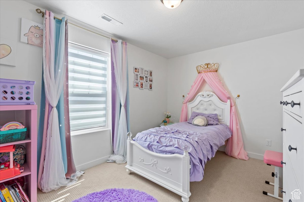 Carpeted bedroom with multiple windows