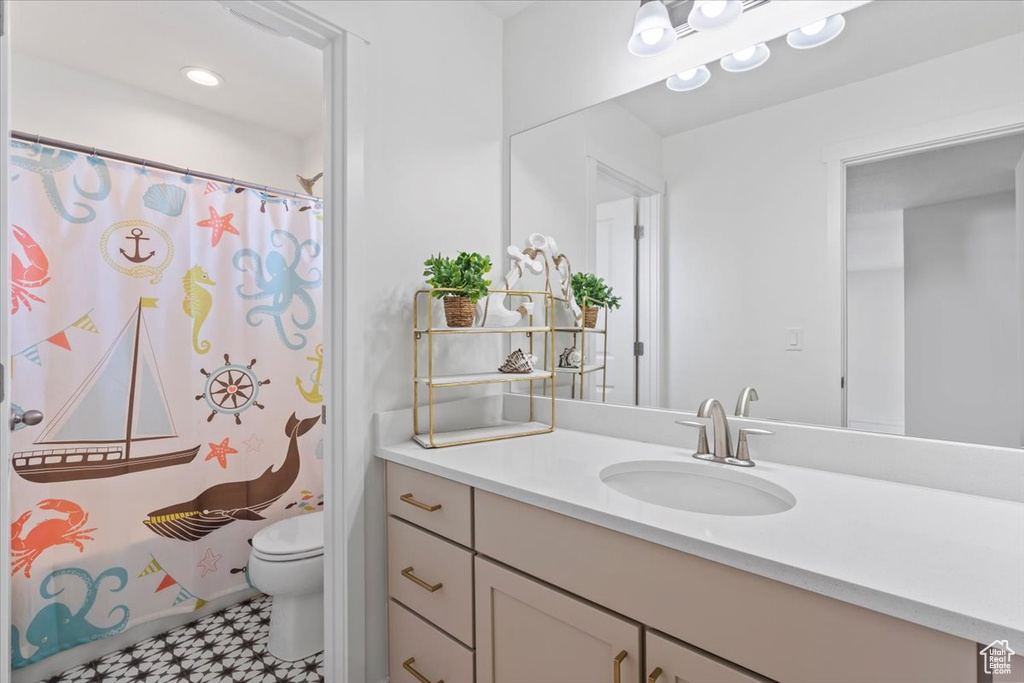 Bathroom with vanity, tile patterned floors, and a shower with shower curtain