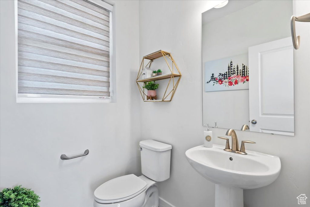 Half bathroom with toilet and a sink