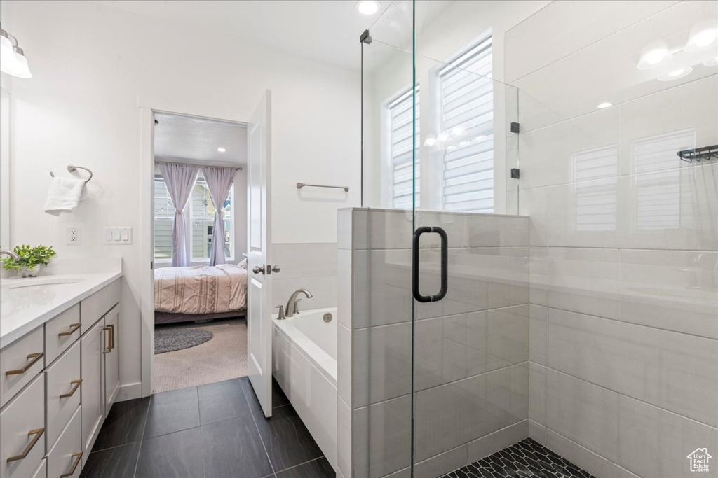 Ensuite bathroom with vanity, a stall shower, a garden tub, and tile patterned floors