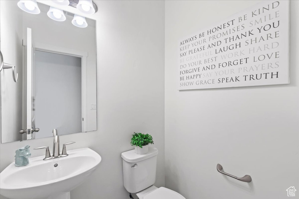 Bathroom featuring a sink and toilet