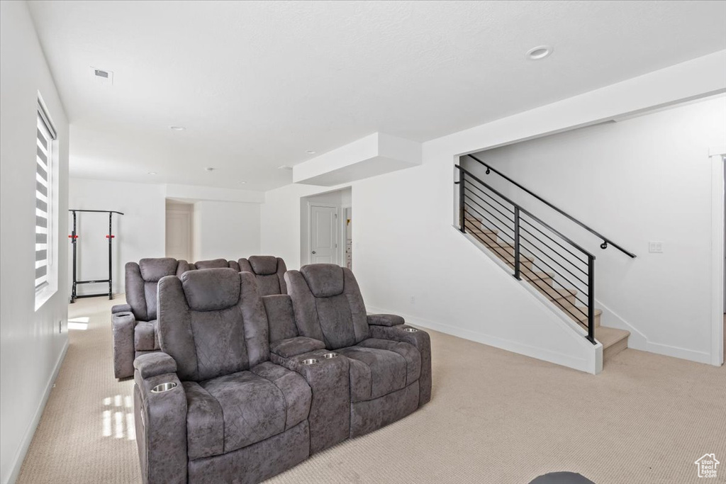 Cinema room featuring carpet floors and baseboards