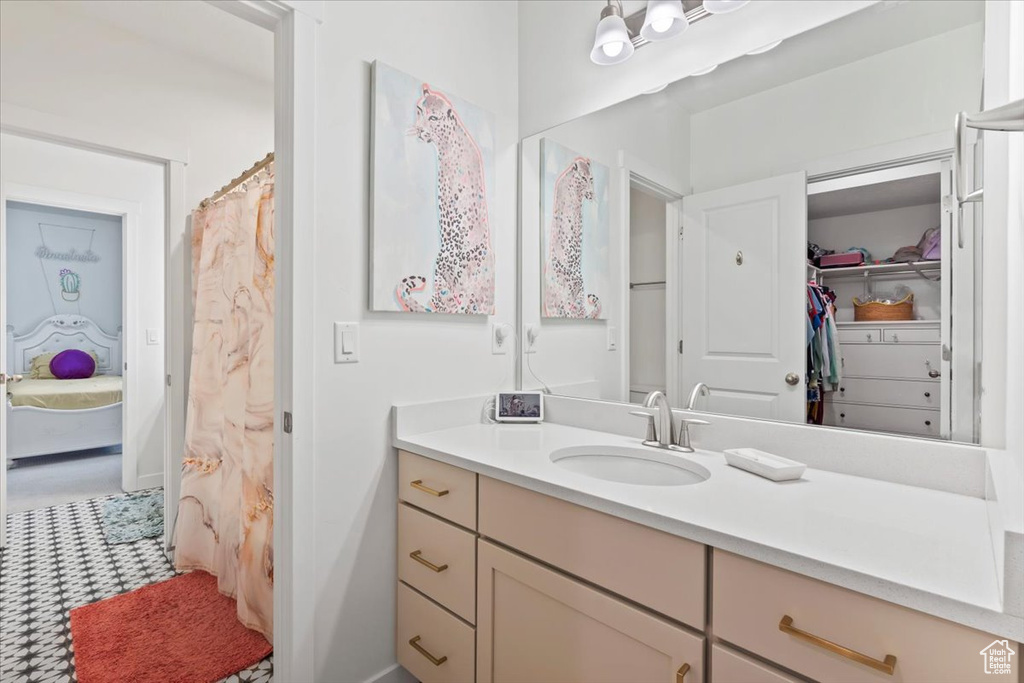 Bathroom with vanity and a spacious closet