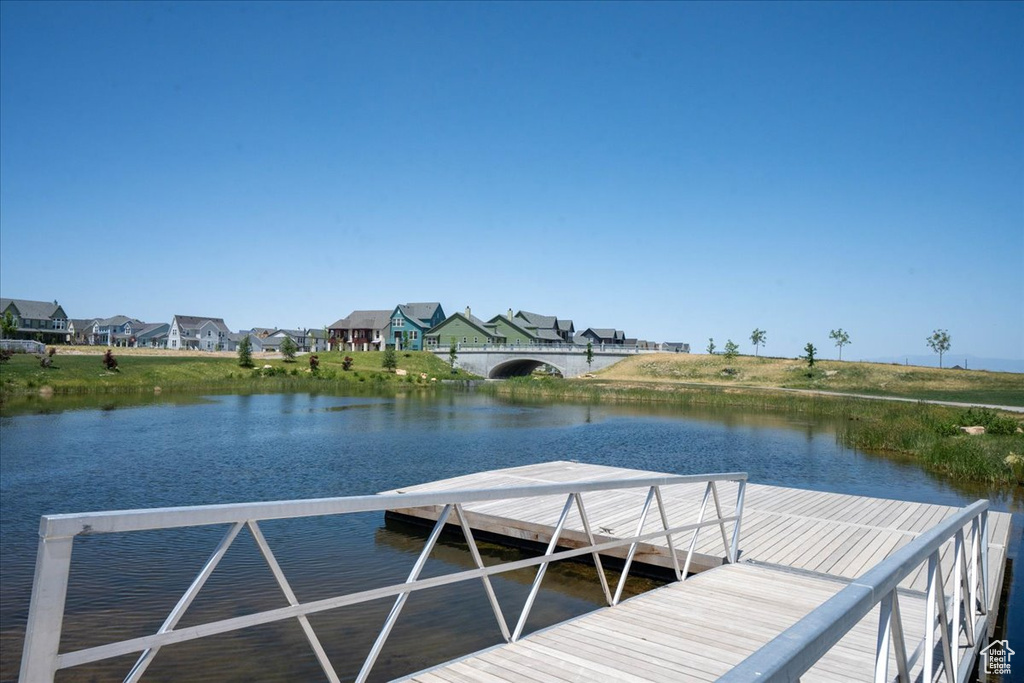 Dock featuring a water view and a residential view