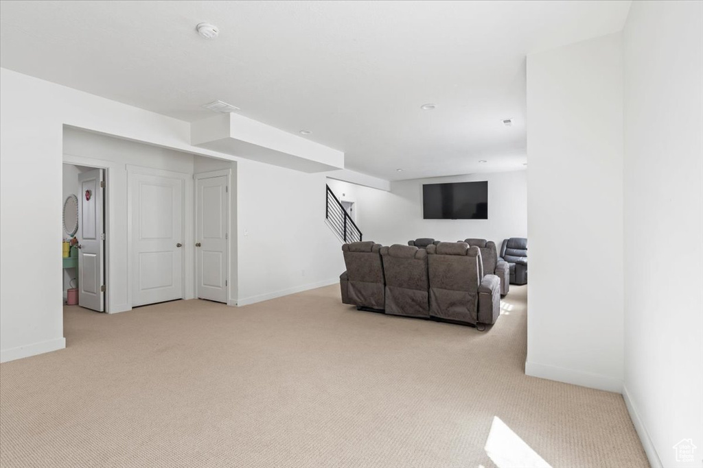 Living room featuring carpet and stairway