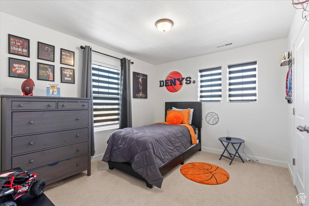 Carpeted bedroom featuring baseboards