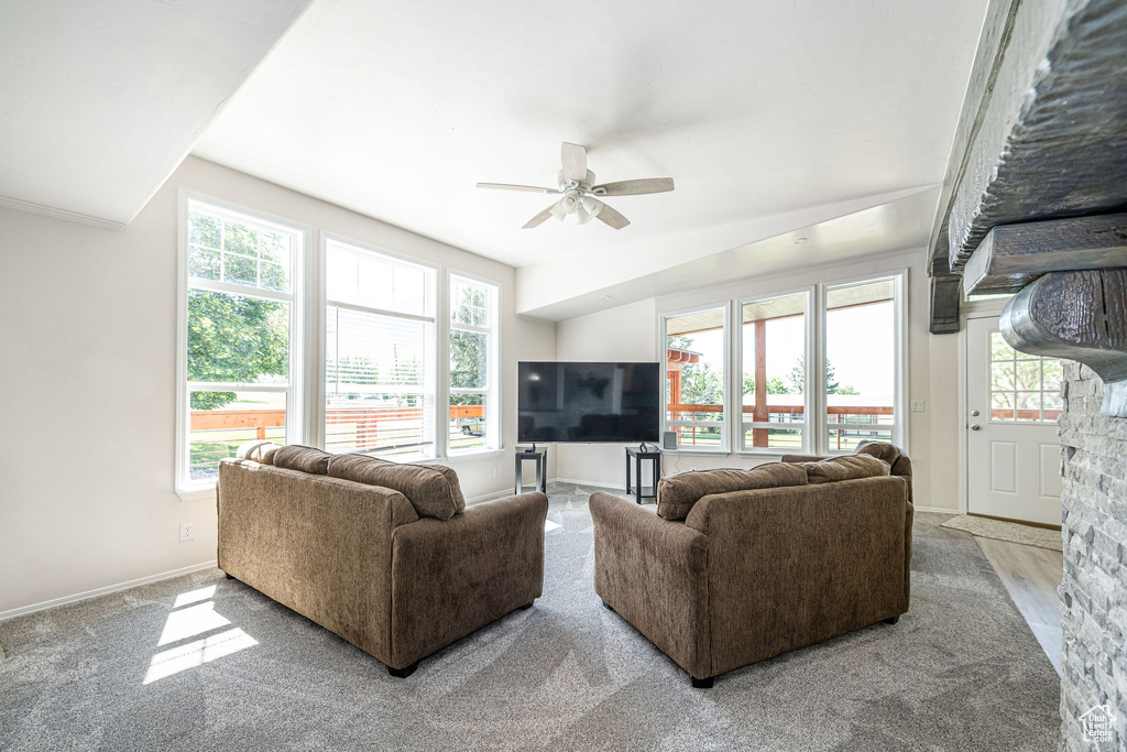 Living area featuring a ceiling fan and baseboards