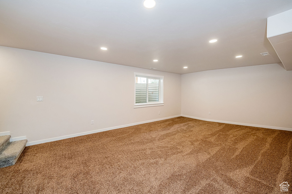 Below grade area featuring carpet floors, recessed lighting, and stairway