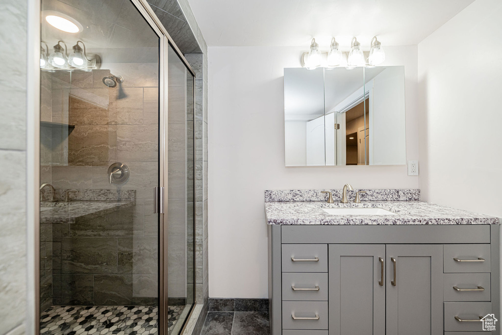 Full bathroom with a shower stall and vanity