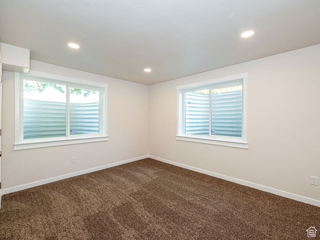 Unfurnished room featuring dark carpet and recessed lighting