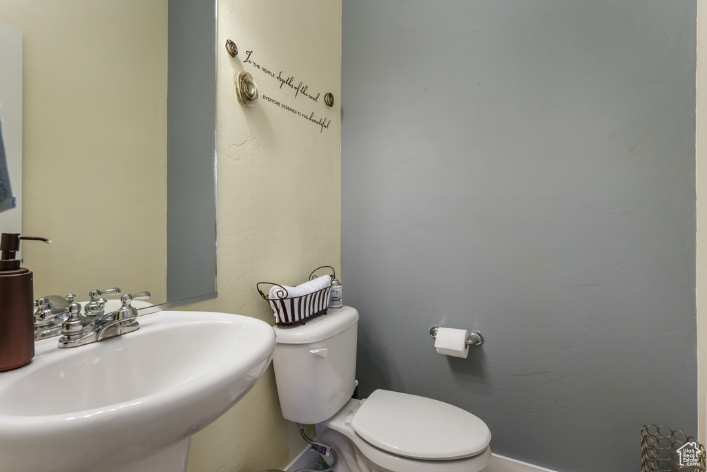Half bathroom with a sink and toilet