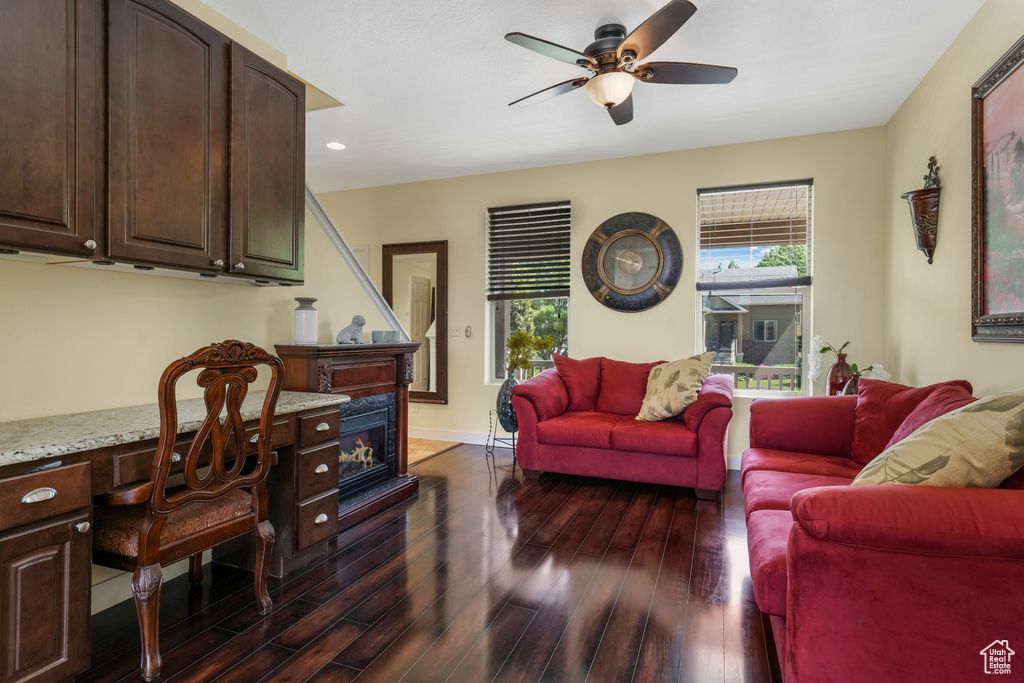 Living area featuring a ceiling fan, dark wood-style floors, a desk, and recessed lighting