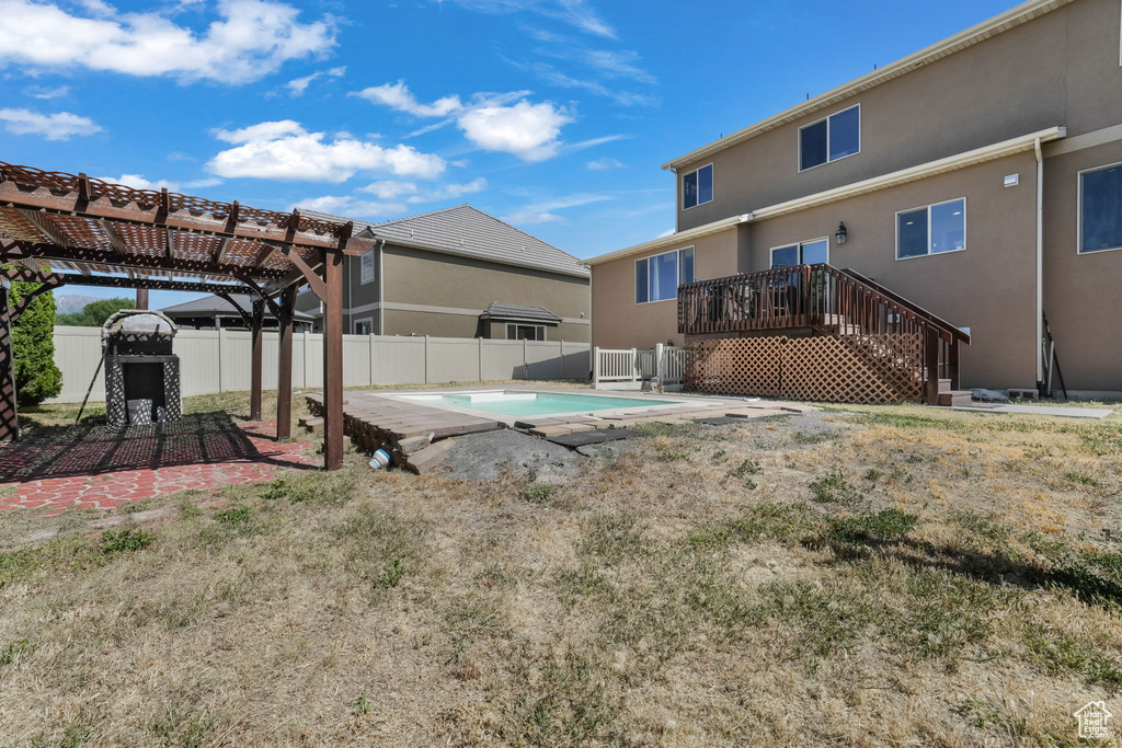 Fenced backyard with a pergola and stairway