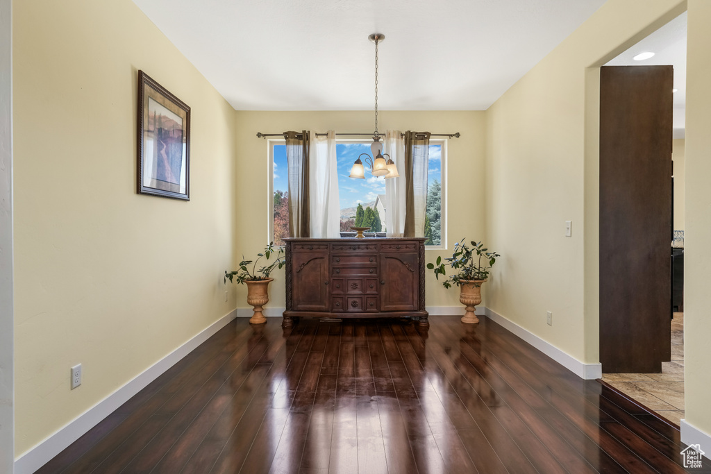 Dining space with dark wood finished floors and baseboards
