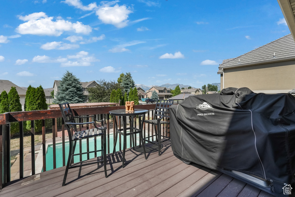 Wooden deck with a swimming pool and a residential view