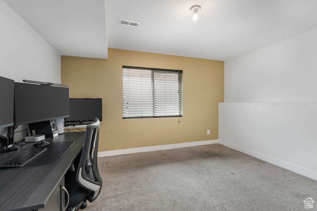 Home office with baseboards and carpet floors