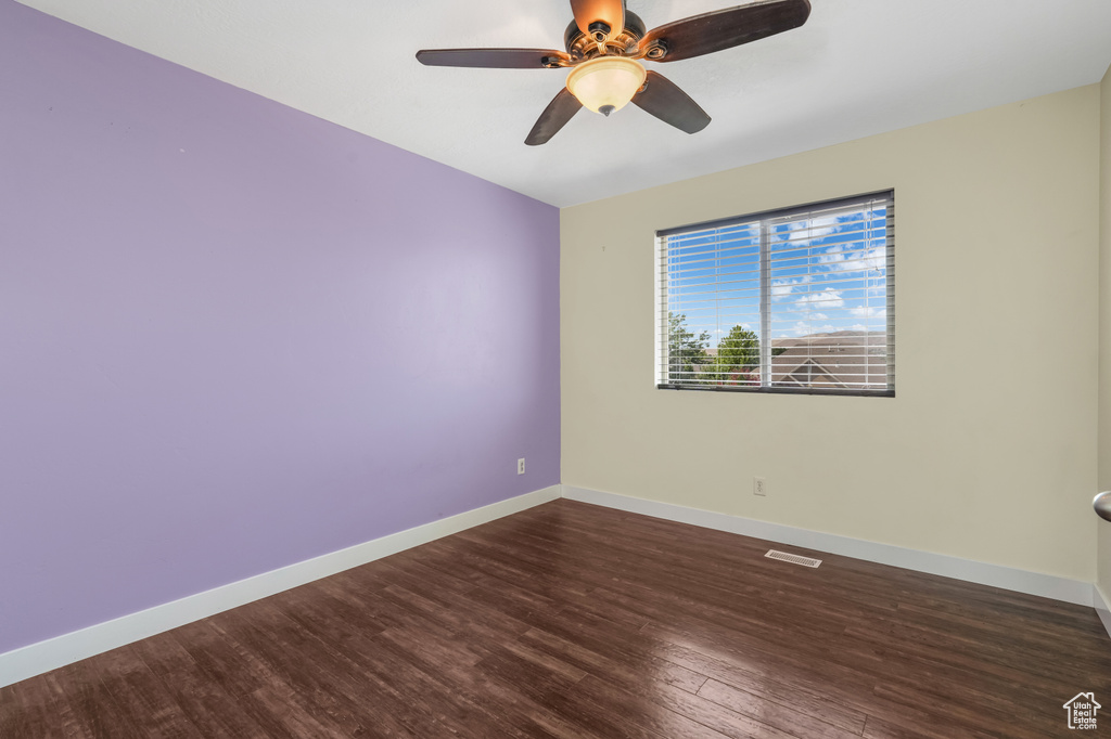 Spare room featuring wood finished floors and ceiling fan