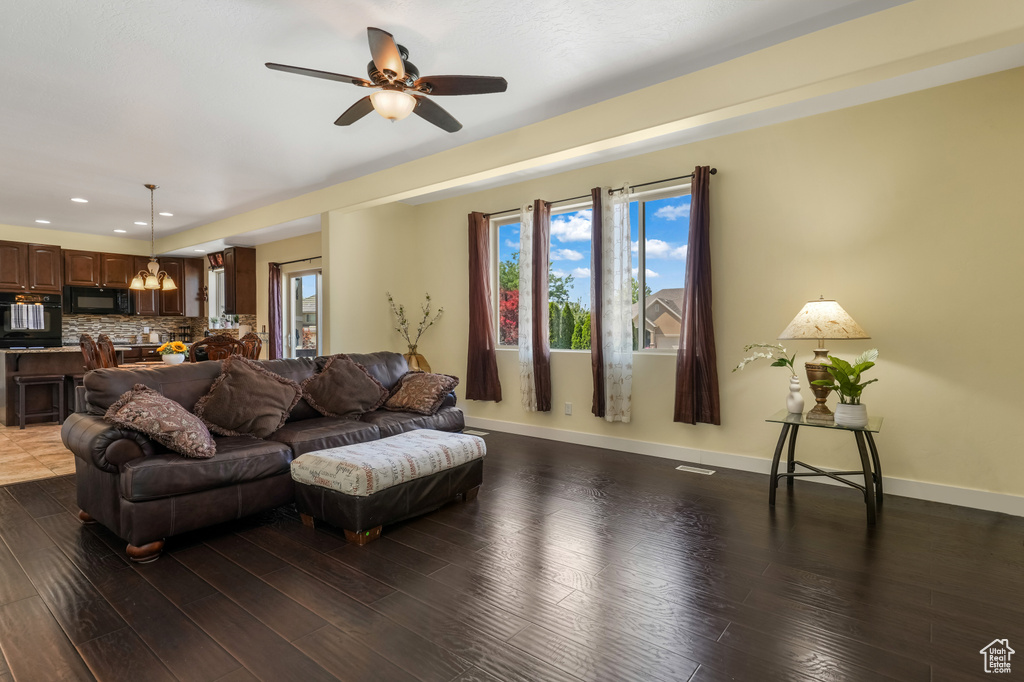 Living room featuring recessed lighting, ceiling fan, and wood finished floors