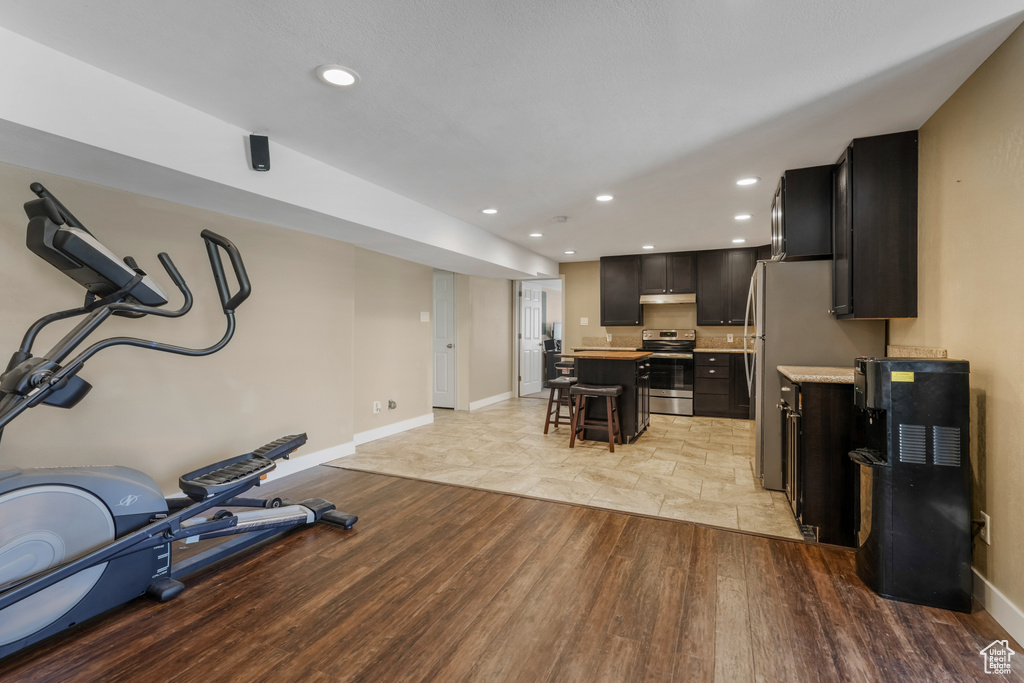 Workout room featuring light wood-style flooring and recessed lighting