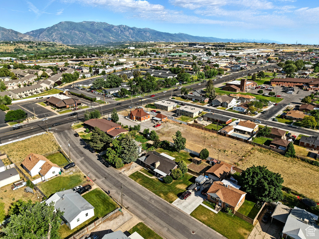Aerial overview of property's location featuring mountains and nearby suburban area