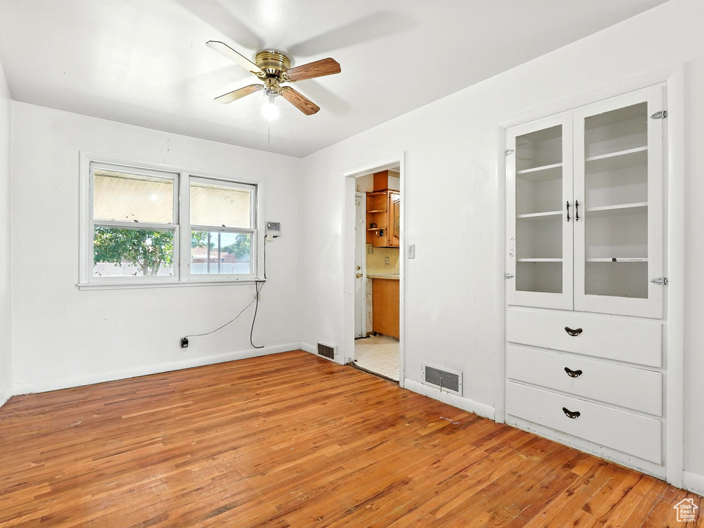 Unfurnished bedroom featuring light wood-type flooring and baseboards