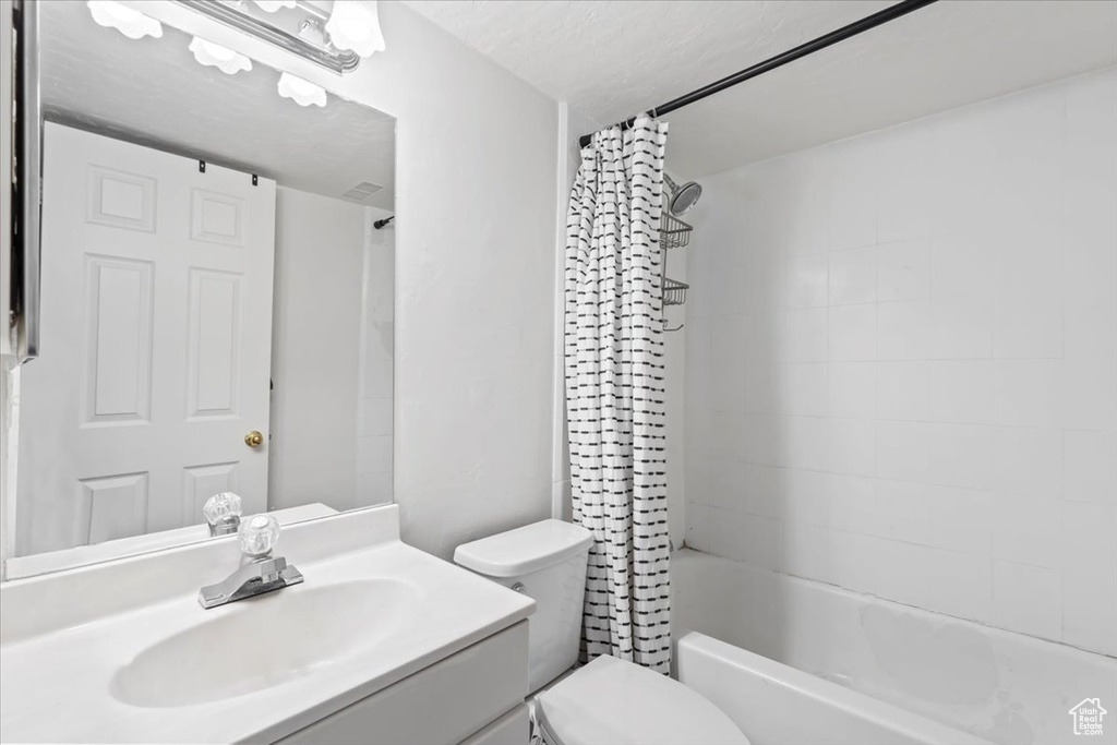 Full bath with vanity and shower / bath combination with curtain