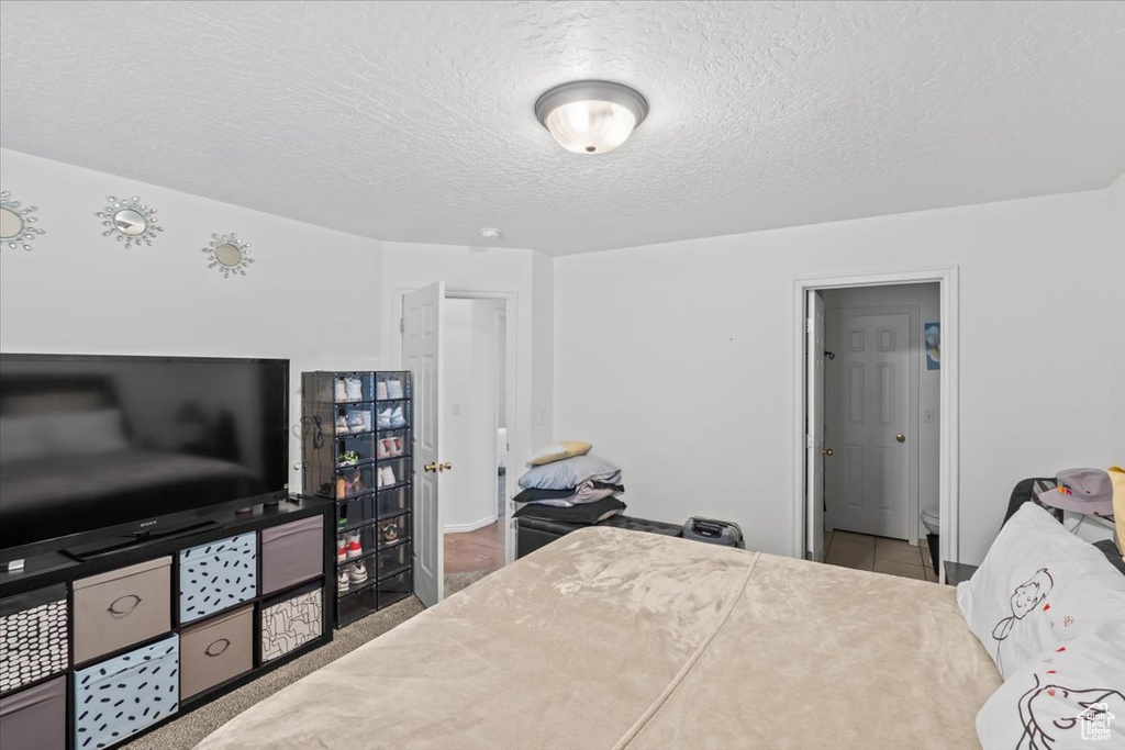 Bedroom with a textured ceiling