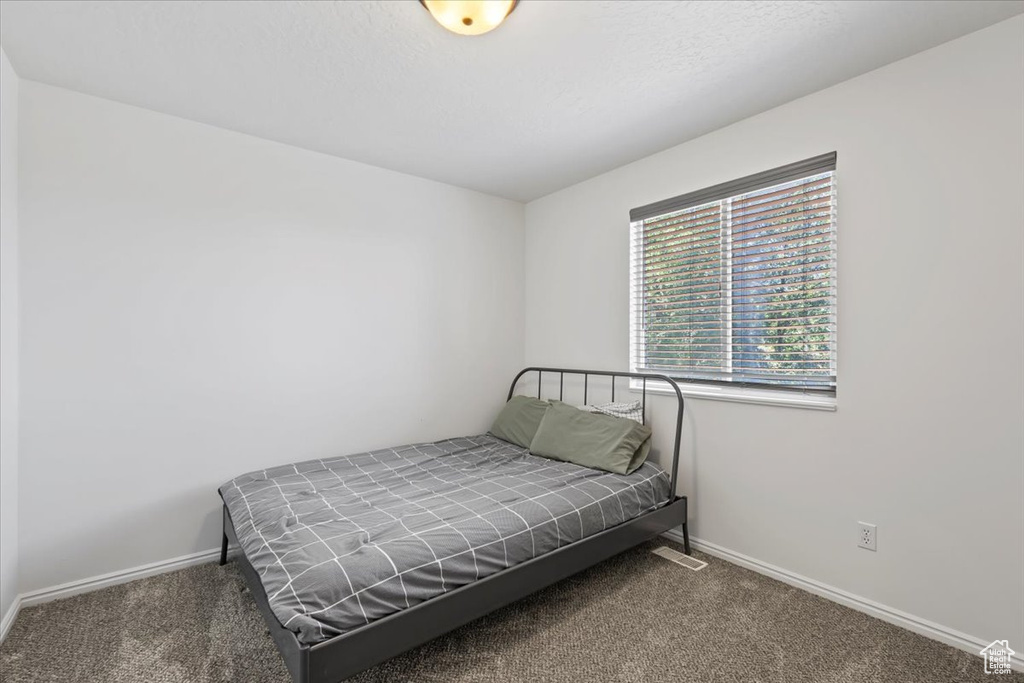 Bedroom with carpet and baseboards