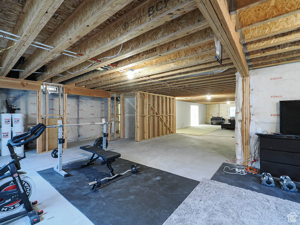 Workout area featuring strapped water heater
