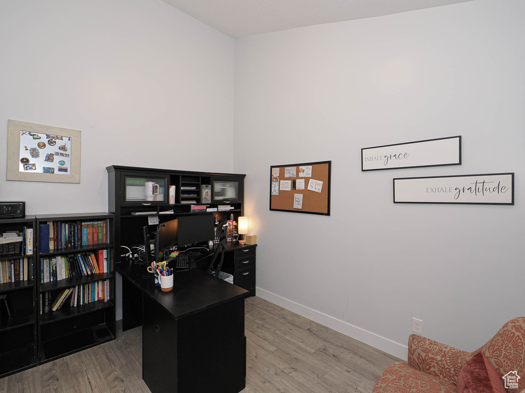 Office space featuring wood finished floors and baseboards