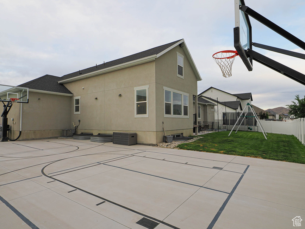 View of sport court with basketball court and a playground