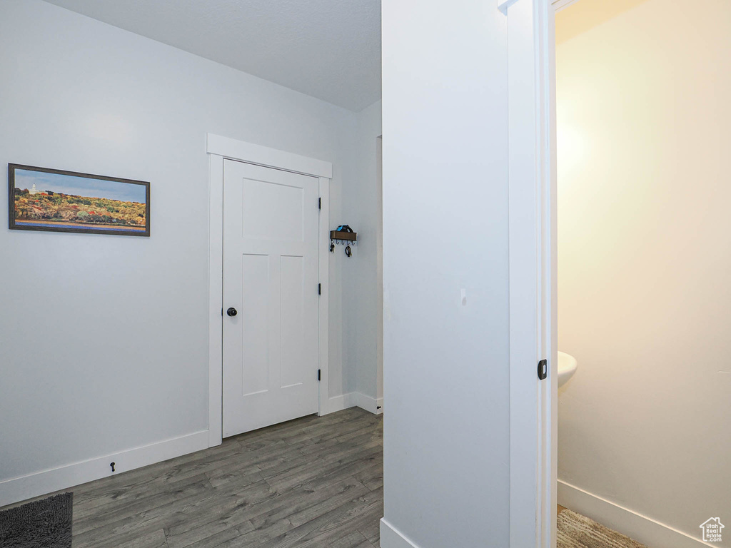 Hallway featuring wood finished floors and baseboards