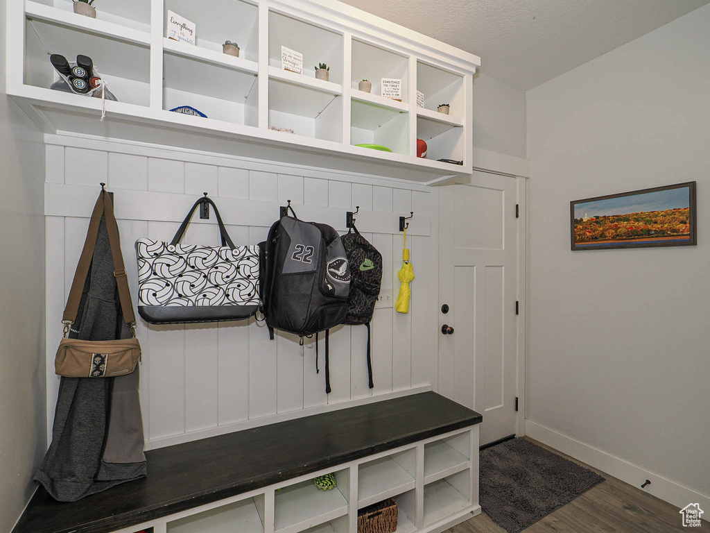 Mudroom featuring wood finished floors and baseboards