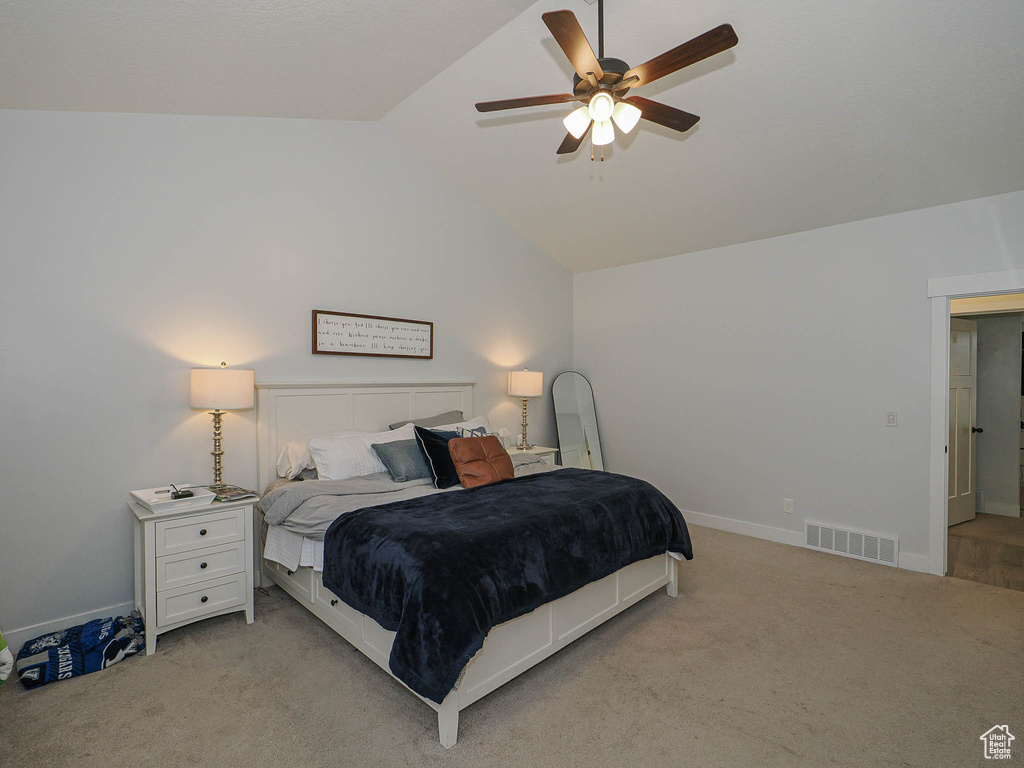 Bedroom with vaulted ceiling, carpet, and ceiling fan