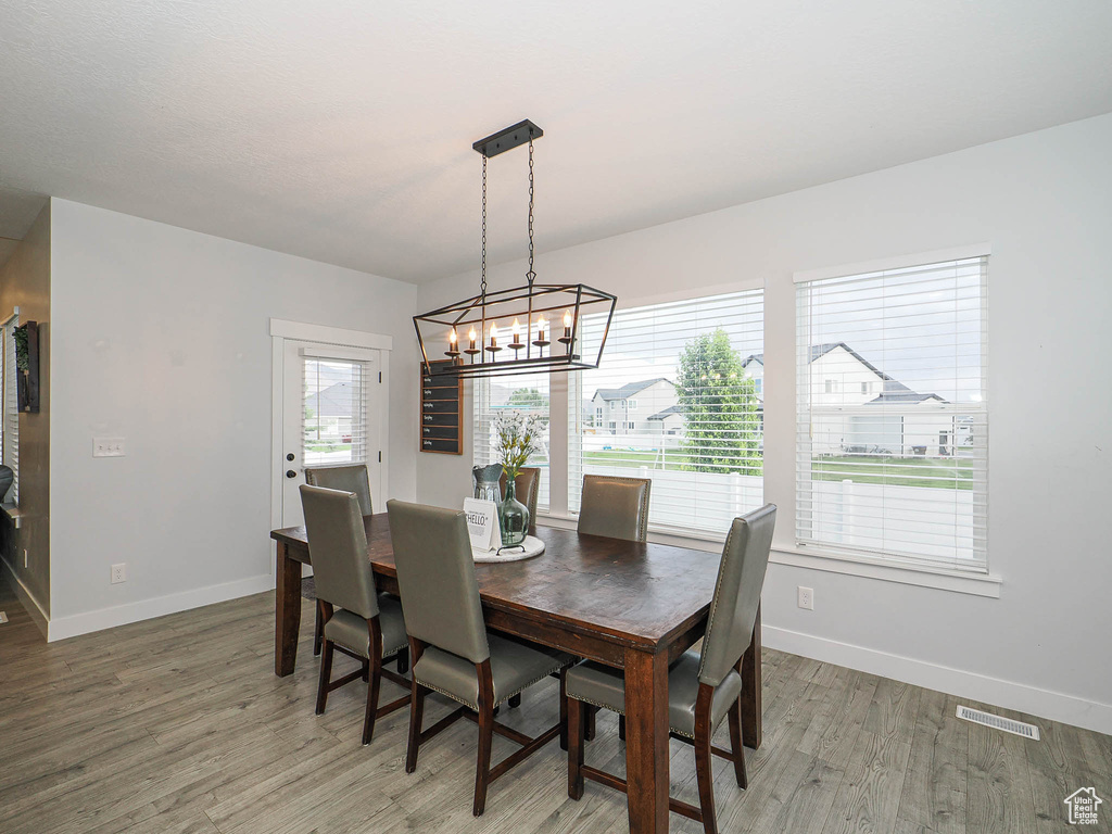 Dining area with a chandelier and light wood finished floors