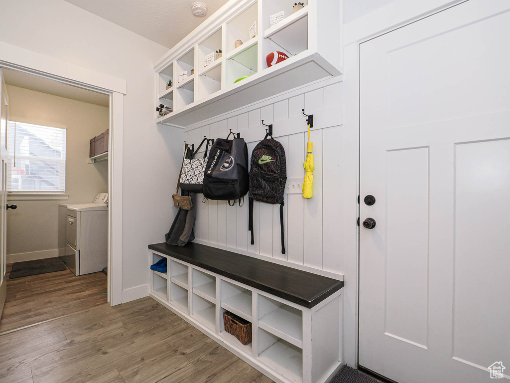 Mudroom with washing machine and clothes dryer and light wood-style flooring