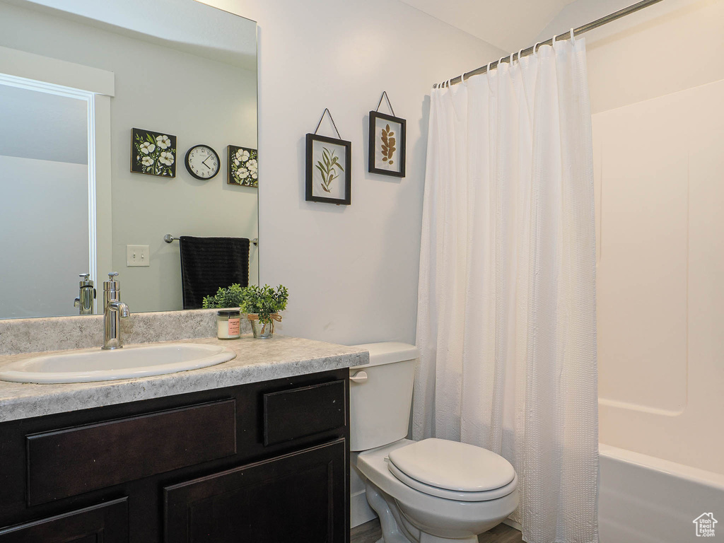 Bathroom with vanity and shower / bath combo with shower curtain