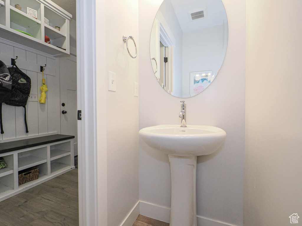Bathroom featuring wood finished floors and baseboards