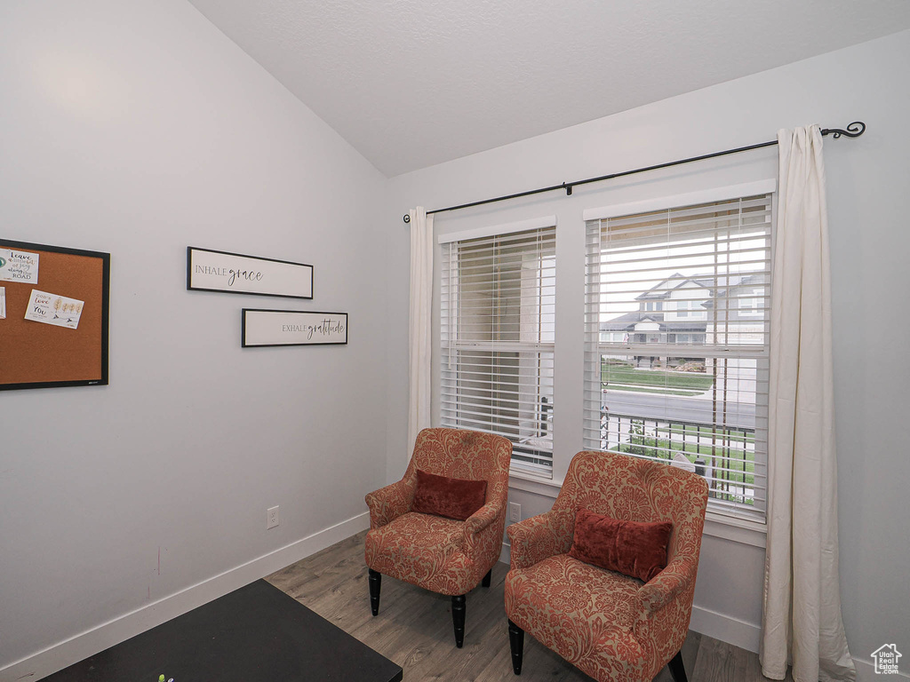 Living area with vaulted ceiling and wood finished floors