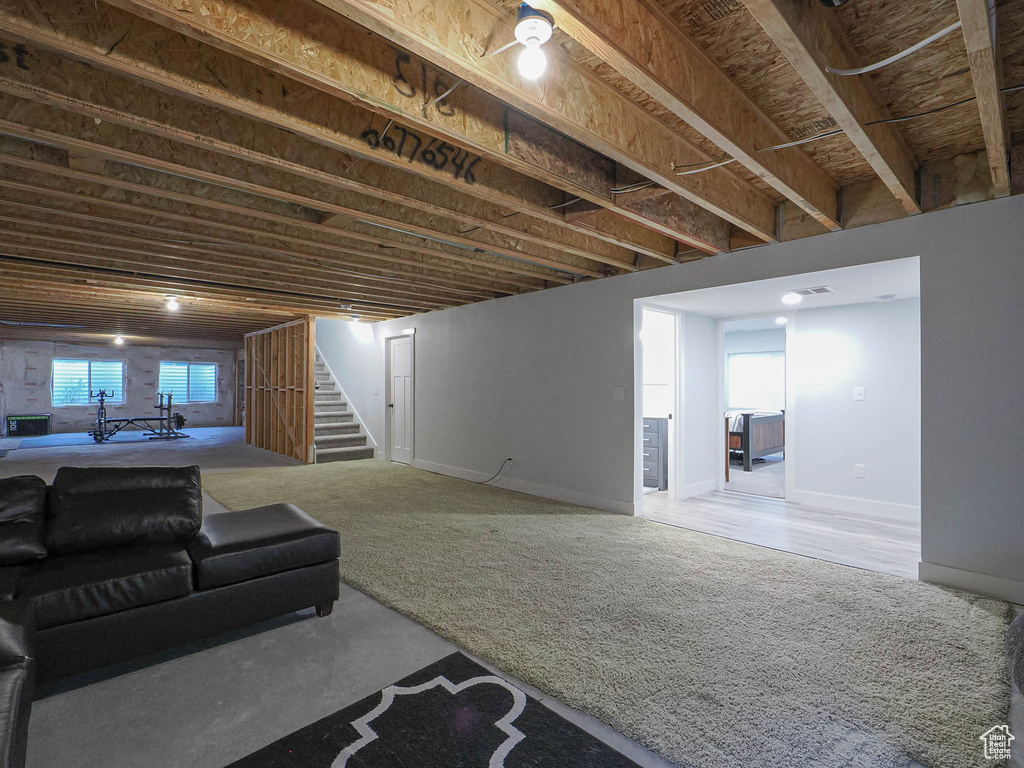 Basement featuring stairs and baseboards