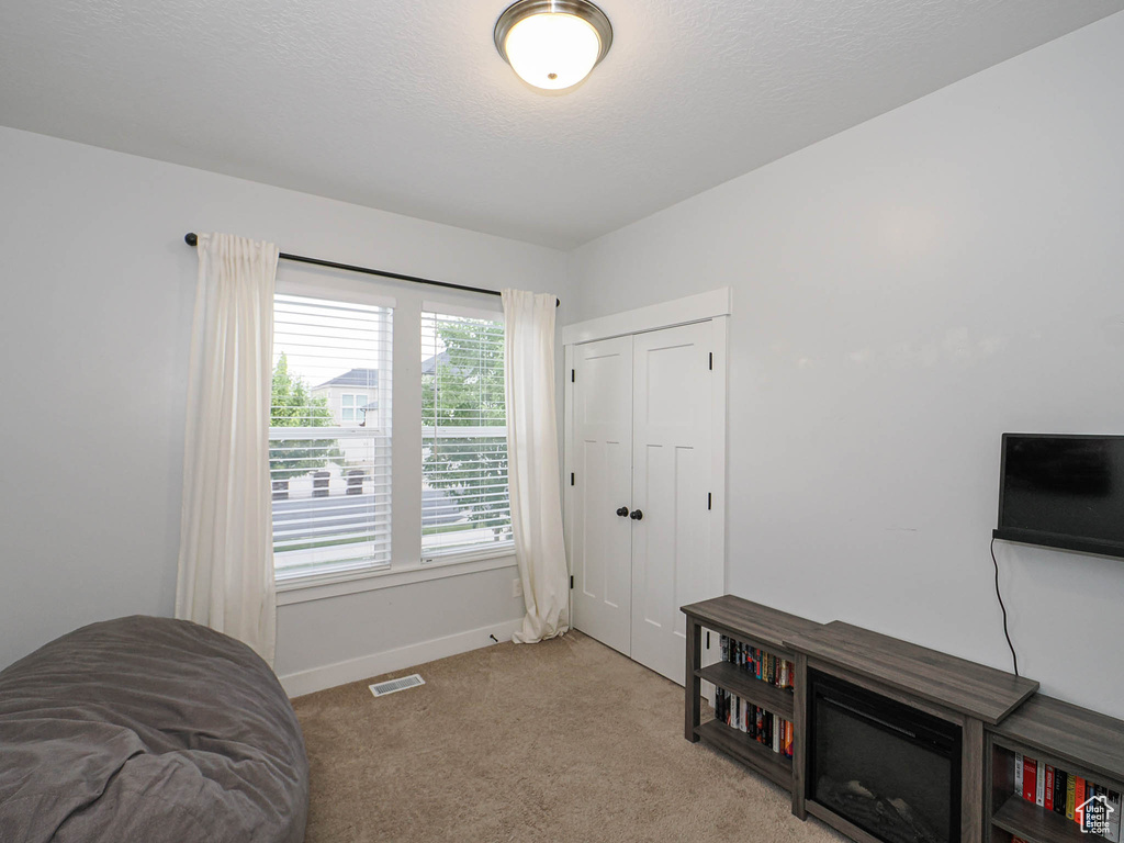 Sitting room with carpet and baseboards