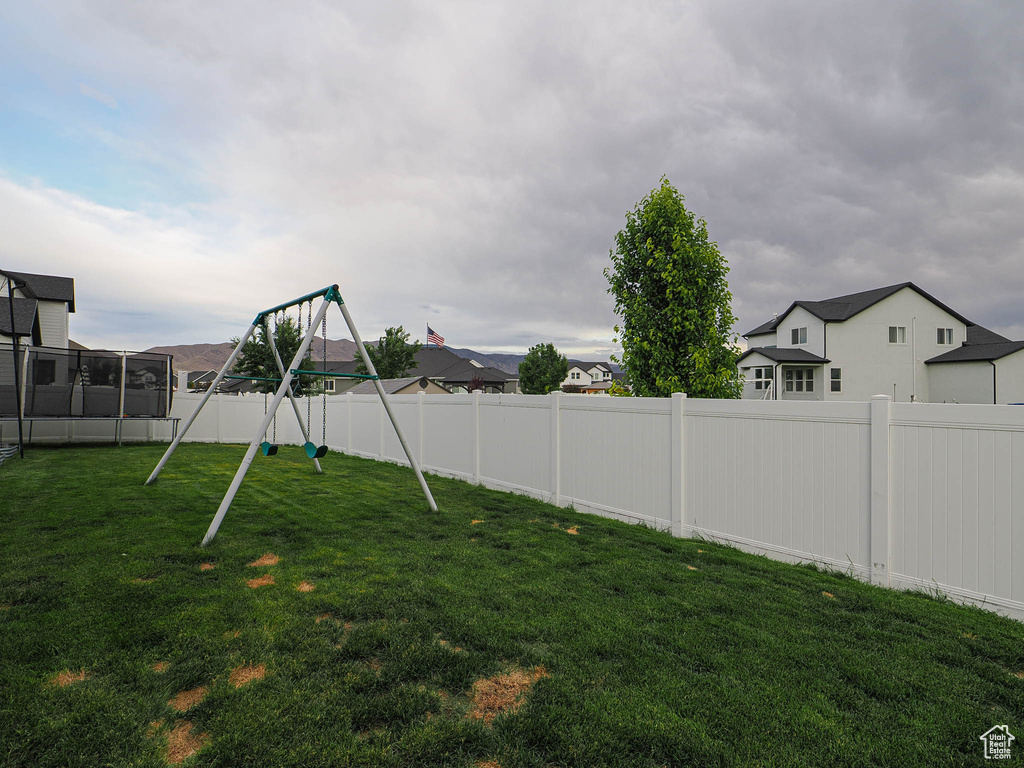 Fenced backyard with a playground