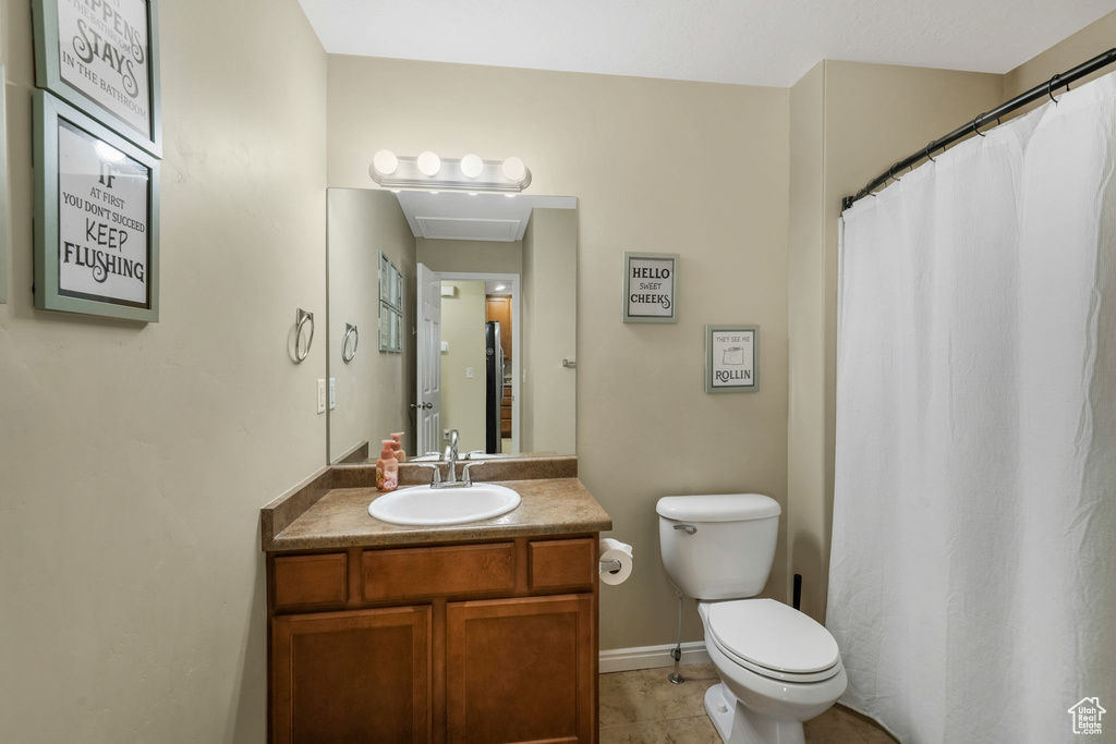 Bathroom with vanity, tile patterned floors, and a shower with shower curtain