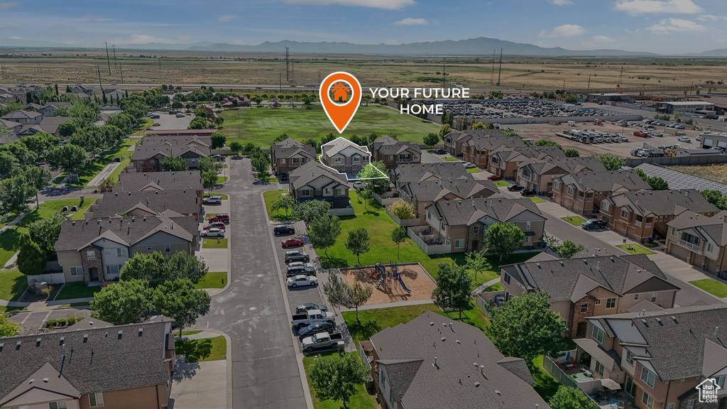 Aerial perspective of suburban area featuring a mountain backdrop